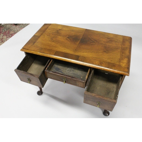 1018 - AN 18TH CENTURY WALNUT LOWBOY with a cross banded and feather banded quarter veneered top, three dra... 