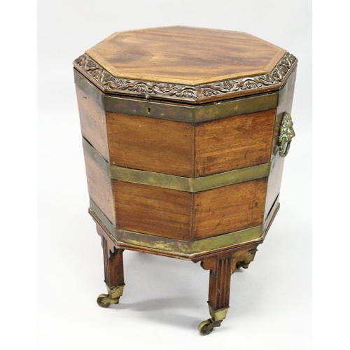 1021 - A GOOD GEORGE III MAHOGANY OCTAGONAL SHAPED CELLERETTE  the rising top with carved edge, brass bound... 