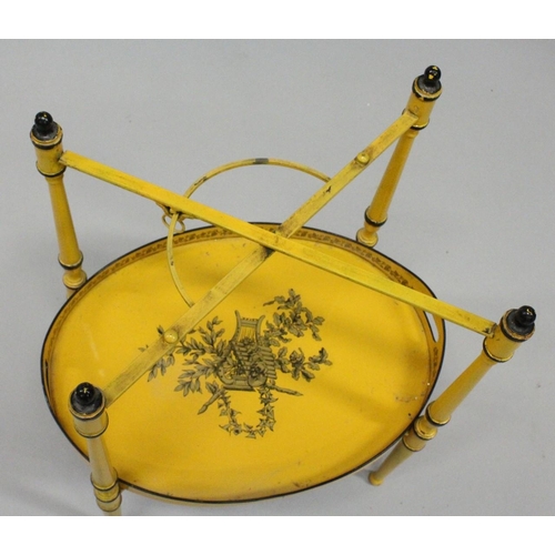 1025 - A GOOD DECORATING TOLEWARE TWO TIER OVAL ETAGERE with lift off trays, yellow ground decorated with c... 