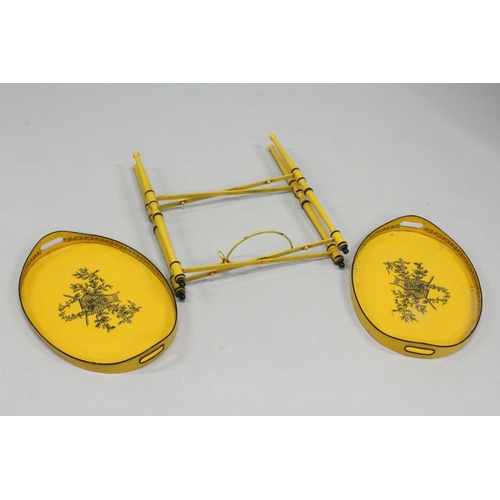 1025 - A GOOD DECORATING TOLEWARE TWO TIER OVAL ETAGERE with lift off trays, yellow ground decorated with c... 