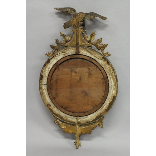 1028 - A REGENCY GILT WOOD CONVEX MIRROR with eagle cresting, ball applied frame and curved decoration to t... 