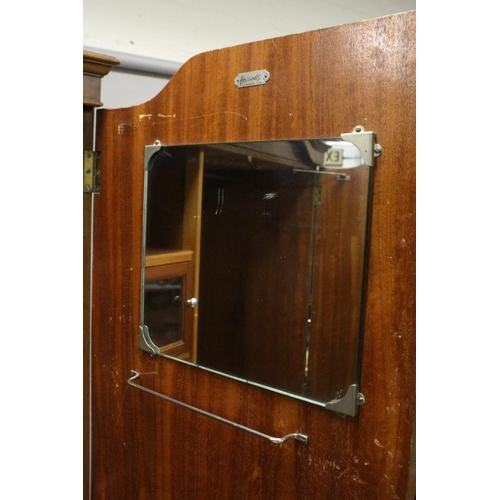 1029 - HARRODS LTD.  A BLONDE WOOD TWO DOOR WARDROBE with shaped cornice, fitted interior on cabriole legs.... 