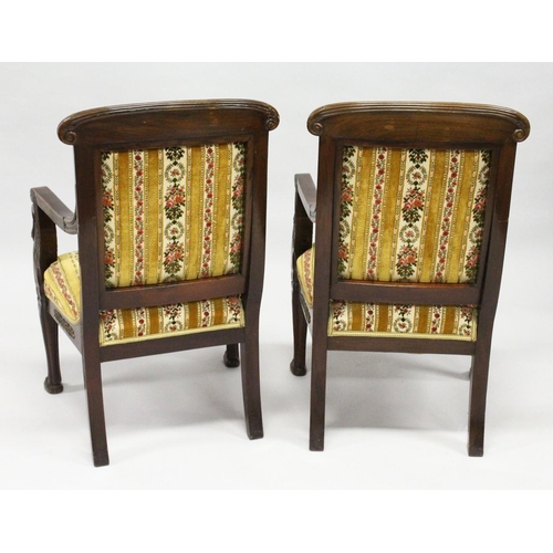 1030 - A GOOD PAIR OF FRENCH EMPIRE MAHOGANY OPEN ARMCHAIRS with reeded curving and cresting rails, upholst... 