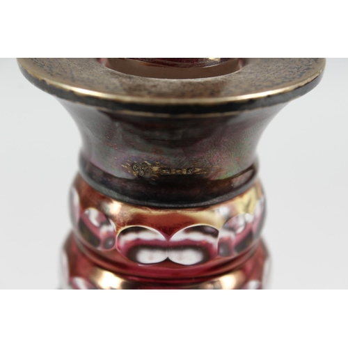 1062 - A VERY GOOD CUT GLASS PLAIN AND RUBY DECANTER AND STOPPER with silver band. 11ins high.