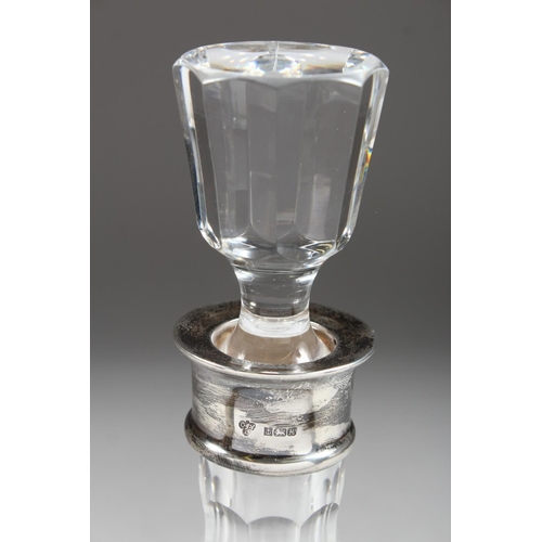 1063 - A VERY GOOD CUT GLASS DECANTER AND STOPPERS with fruiting vines and silver band.