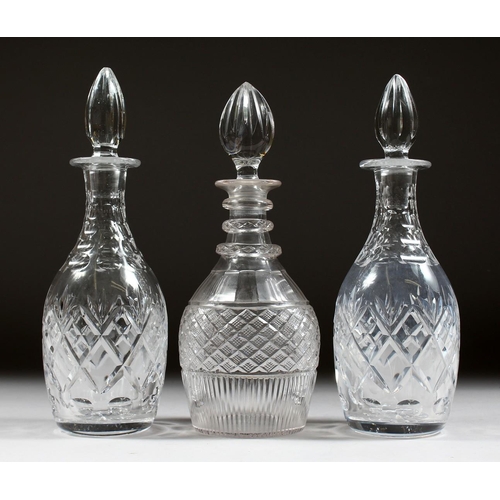 1064 - A PAIR OF CUT GLASS SHERRY DECANTERS AND STOPPERS and ANOTHER.  (3).