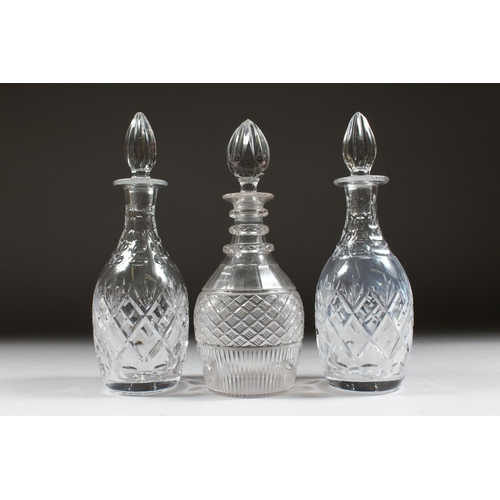 1064 - A PAIR OF CUT GLASS SHERRY DECANTERS AND STOPPERS and ANOTHER.  (3).