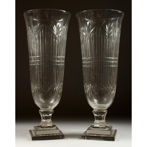 1075 - A GOOD PAIR OF CUT GLASS TAPERING VASES on stepped square bases. 17ins high.