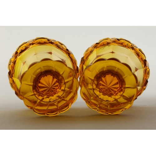 1079 - A PAIR OF BOHEMIAN AMBER GLASS PEDESTAL SALTS.