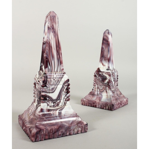 1080 - A PAIR OF SLAG GLASS MARBLE OBELISKS. 8ins high.