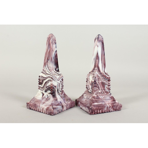 1080 - A PAIR OF SLAG GLASS MARBLE OBELISKS. 8ins high.