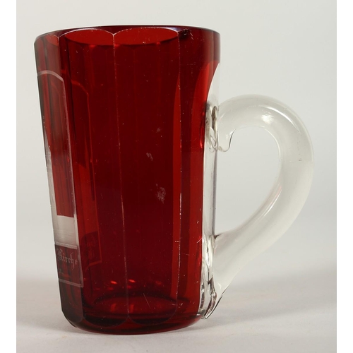 1081 - A BOHEMIAN RUBY GLASS TANKARD engraved with a church. 4.5ins high.