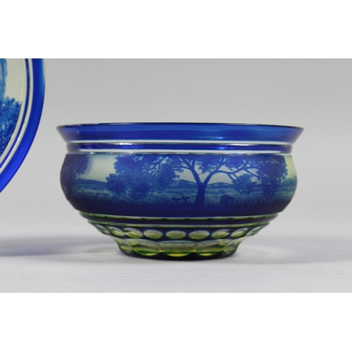 1084 - A BOHEMIAN BLUE TINTED BOWL AND STAND with a landscaped decoration.