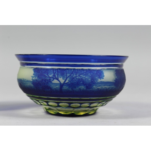 1084 - A BOHEMIAN BLUE TINTED BOWL AND STAND with a landscaped decoration.