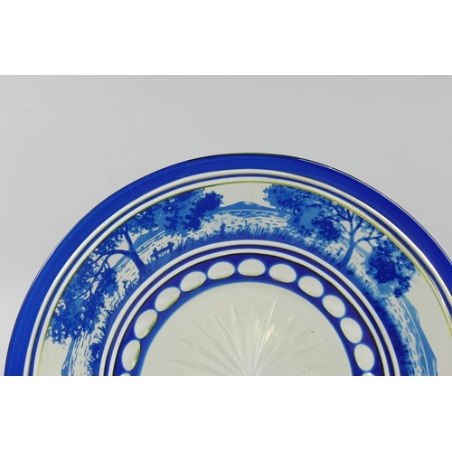 1084 - A BOHEMIAN BLUE TINTED BOWL AND STAND with a landscaped decoration.