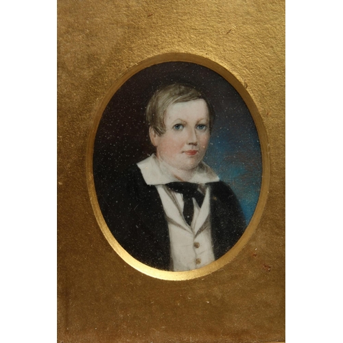 1092 - A FRAMED MINIATURE PORTRAIT OF A SCHOOL BOY MOULD in a gilded frame.