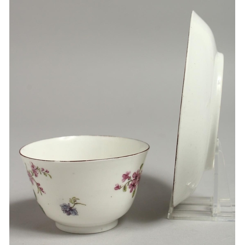 1096 - AN 18TH CENTURY CHELSEA RED ANCHOR MARKED TEA BOWL AND SAUCER painted with Meissen style flowers.