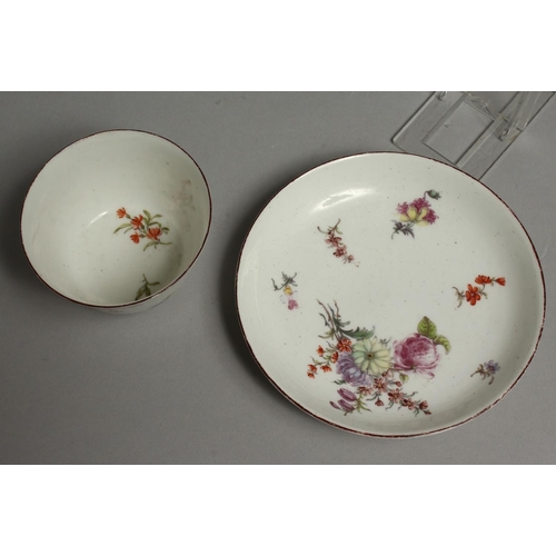 1096 - AN 18TH CENTURY CHELSEA RED ANCHOR MARKED TEA BOWL AND SAUCER painted with Meissen style flowers.