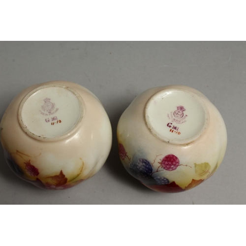 1110 - A PAIR OF ROYAL WORCESTER VASES painted with autumnal leaves and berries by Kitty Blake. Signed K. B... 