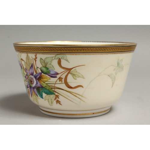 1113 - A ROYAL WORCESTER BOWL painted with a gilt and black border painted with passion flowers.