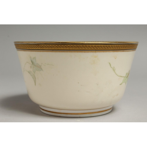 1113 - A ROYAL WORCESTER BOWL painted with a gilt and black border painted with passion flowers.