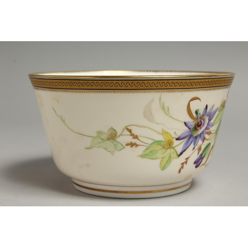 1113 - A ROYAL WORCESTER BOWL painted with a gilt and black border painted with passion flowers.