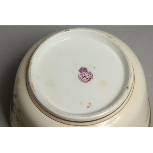 1113 - A ROYAL WORCESTER BOWL painted with a gilt and black border painted with passion flowers.