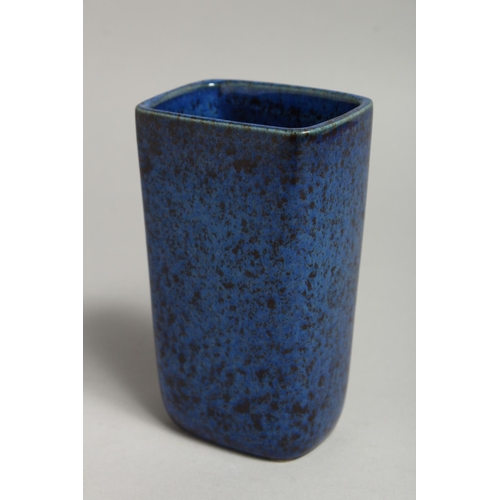 1119 - A SMALL BLUE MOTTLED VASE with sliver flowers, signed. 5ins high.