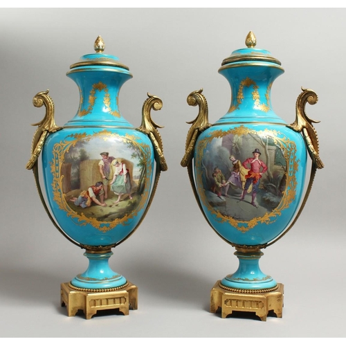 1123 - A SUPERB  PAIR OF 19TH CENTURY SEVRES PALE BLUE, TWO HANDLED URNS AND COVERS, painted with reverse o... 