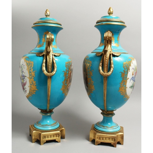 1123 - A SUPERB  PAIR OF 19TH CENTURY SEVRES PALE BLUE, TWO HANDLED URNS AND COVERS, painted with reverse o... 