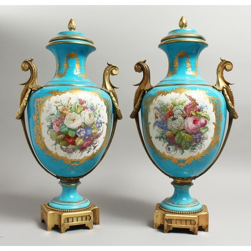 1123 - A SUPERB  PAIR OF 19TH CENTURY SEVRES PALE BLUE, TWO HANDLED URNS AND COVERS, painted with reverse o... 