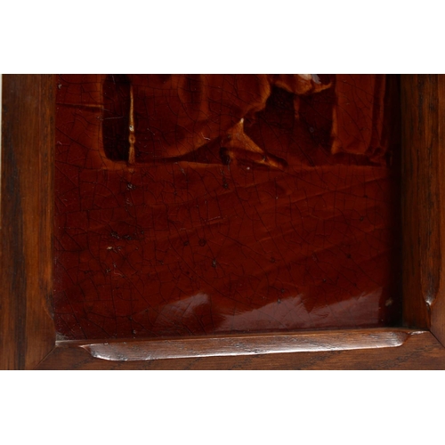 1128 - A VICTORIAN TREACLE GLAZED TILE PANEL depicting figures at a table, in an oak frame, together with a... 