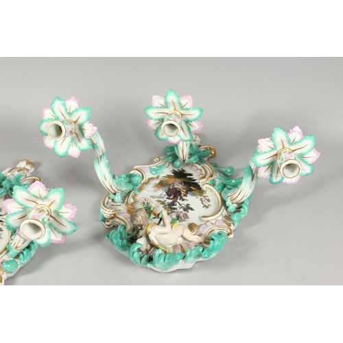 1147 - A PAIR OF THREE-BRANCH PORCELAIN WALL LIGHTS IN THE MEISSEN STYLE, decorated with cherubs, flowers, ... 