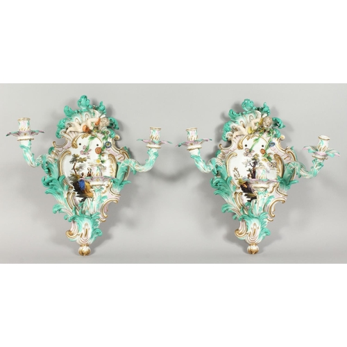 1147 - A PAIR OF THREE-BRANCH PORCELAIN WALL LIGHTS IN THE MEISSEN STYLE, decorated with cherubs, flowers, ... 