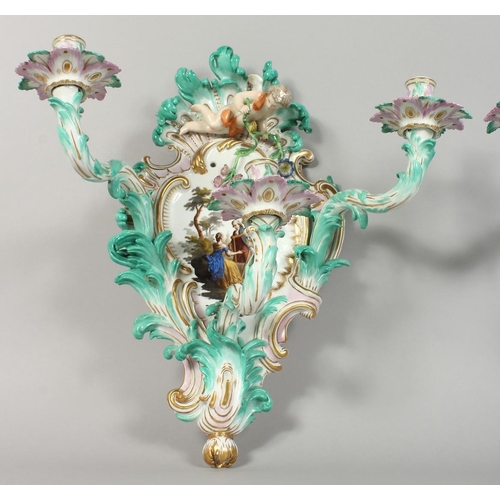 1147 - A PAIR OF THREE-BRANCH PORCELAIN WALL LIGHTS IN THE MEISSEN STYLE, decorated with cherubs, flowers, ... 