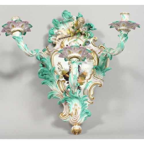 1147 - A PAIR OF THREE-BRANCH PORCELAIN WALL LIGHTS IN THE MEISSEN STYLE, decorated with cherubs, flowers, ... 