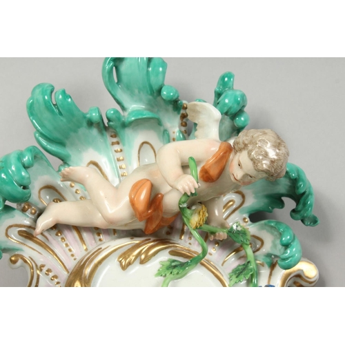 1147 - A PAIR OF THREE-BRANCH PORCELAIN WALL LIGHTS IN THE MEISSEN STYLE, decorated with cherubs, flowers, ... 