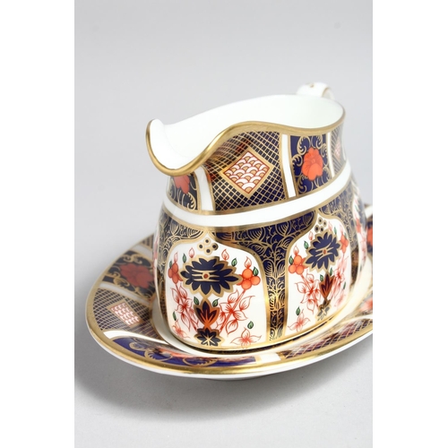 1159 - A  ROYAL CROWN DERBY OLD IMARI PATTERN SAUCE BOAT AND STAND, NO. 1128.