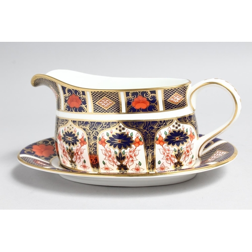 1159 - A  ROYAL CROWN DERBY OLD IMARI PATTERN SAUCE BOAT AND STAND, NO. 1128.