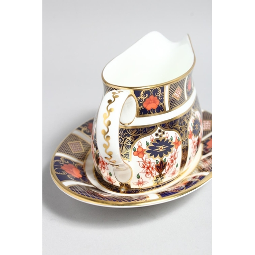 1159 - A  ROYAL CROWN DERBY OLD IMARI PATTERN SAUCE BOAT AND STAND, NO. 1128.