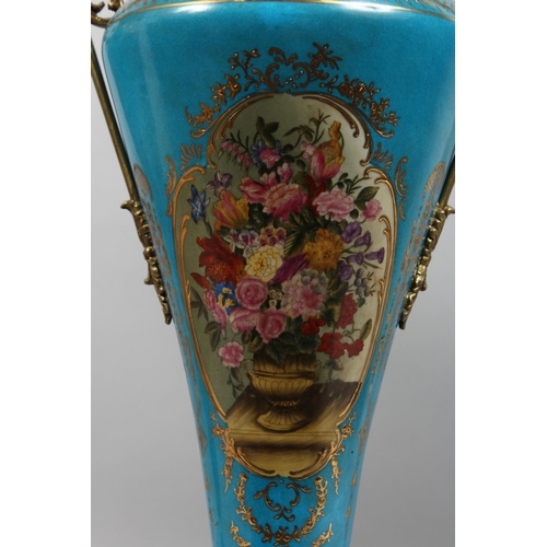 1206 - A PAIR OF SEVRES STYLE PORCELAIN AND ORMOLU TWIN HANDLED VASES AND COVERS decorated with flowers, 27... 