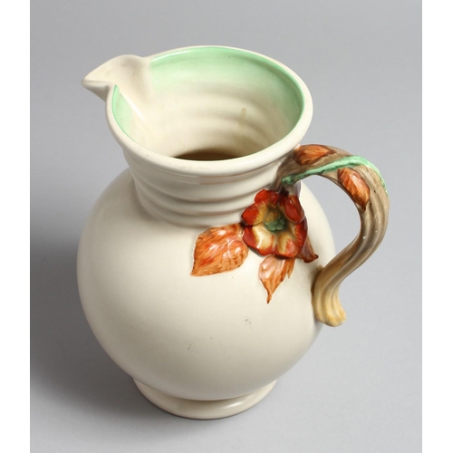 1209 - A CLARICE CLIFF JUG with floral handle. 9ins high.