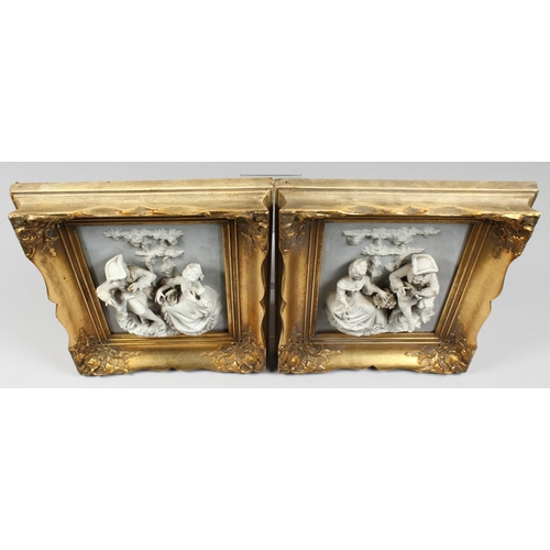 1218 - A PAIR OF GILT FRAMED BISQUE PLAQUES of a gallant and a young lady. 9ins x 6.5ins.