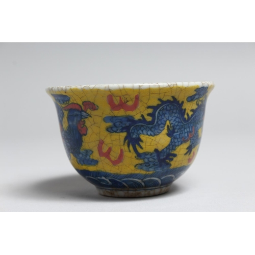 1228 - A SMALL PORCELAIN TEA BOWL painted with a  bird and dragon. 3.5ins diameter.