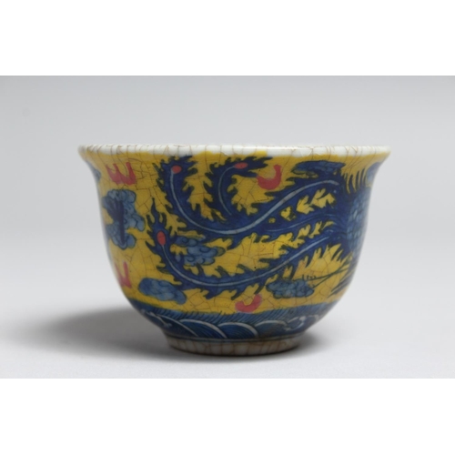 1228 - A SMALL PORCELAIN TEA BOWL painted with a  bird and dragon. 3.5ins diameter.