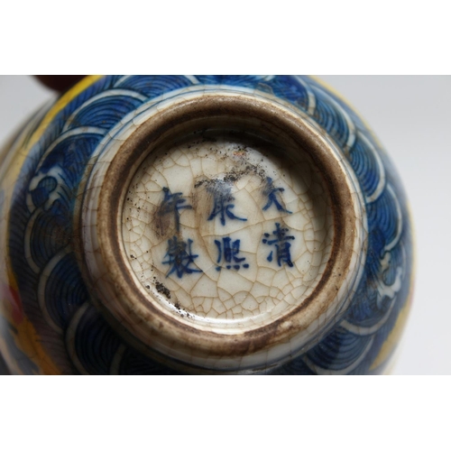 1228 - A SMALL PORCELAIN TEA BOWL painted with a  bird and dragon. 3.5ins diameter.