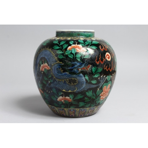 1232 - A CHINESE FAMILLE NOIR PORCELAIN JAR. 7ins high.