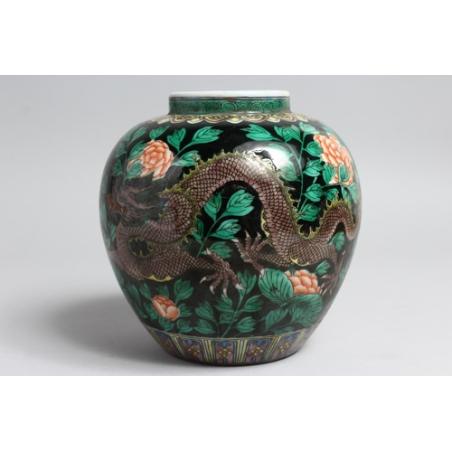 1232 - A CHINESE FAMILLE NOIR PORCELAIN JAR. 7ins high.