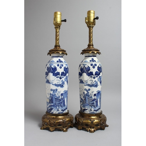 1238 - A PAIR OF CHINESE BLUE AND WHITE PORCELAIN LAMPS with ormolu mounts. 19ins high.