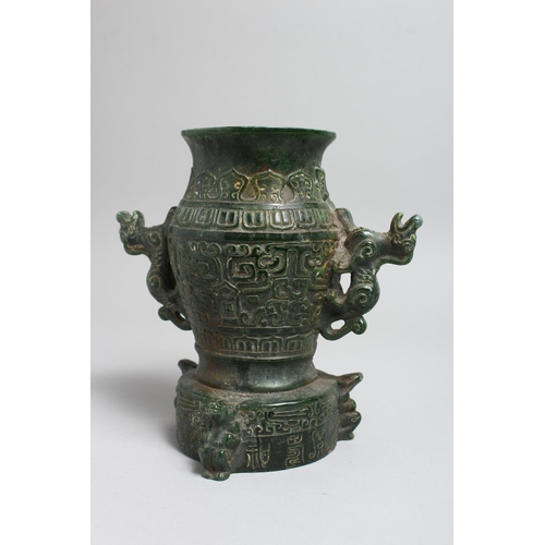 1240 - A CHINESE ARCHAIC STYLE JADEITE TWIN HANDLED VASE. 8ins high.